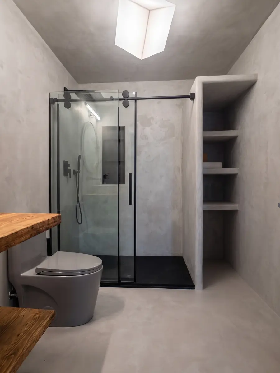 Microcement bathroom walls and floor with a glass shower in Boston