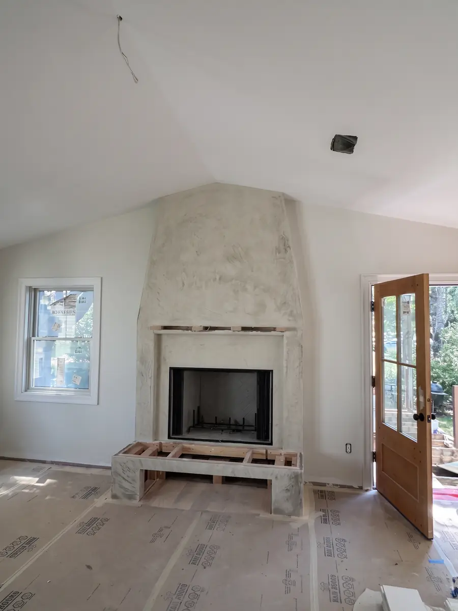 Hand-applied plaster fireplace surround and bench in New Hampshire