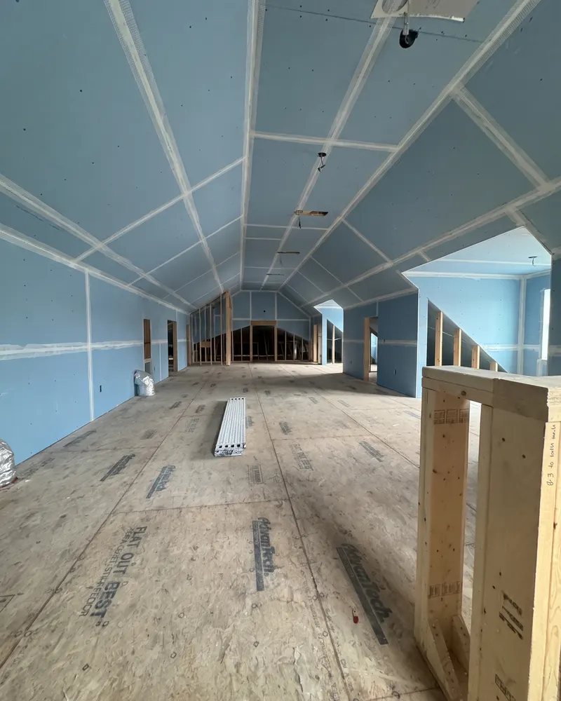 Attic walls and ceilings covered in blueboard, ready for plaster