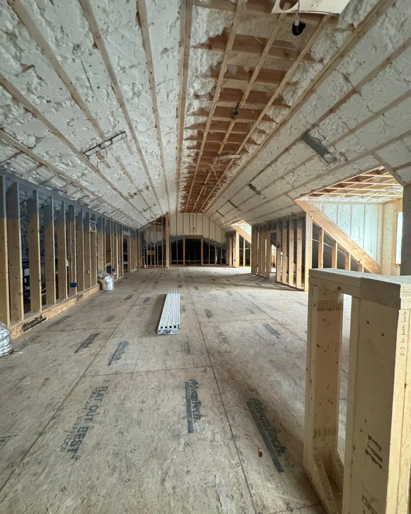 Attic framing and spray foam insulation before blueboard