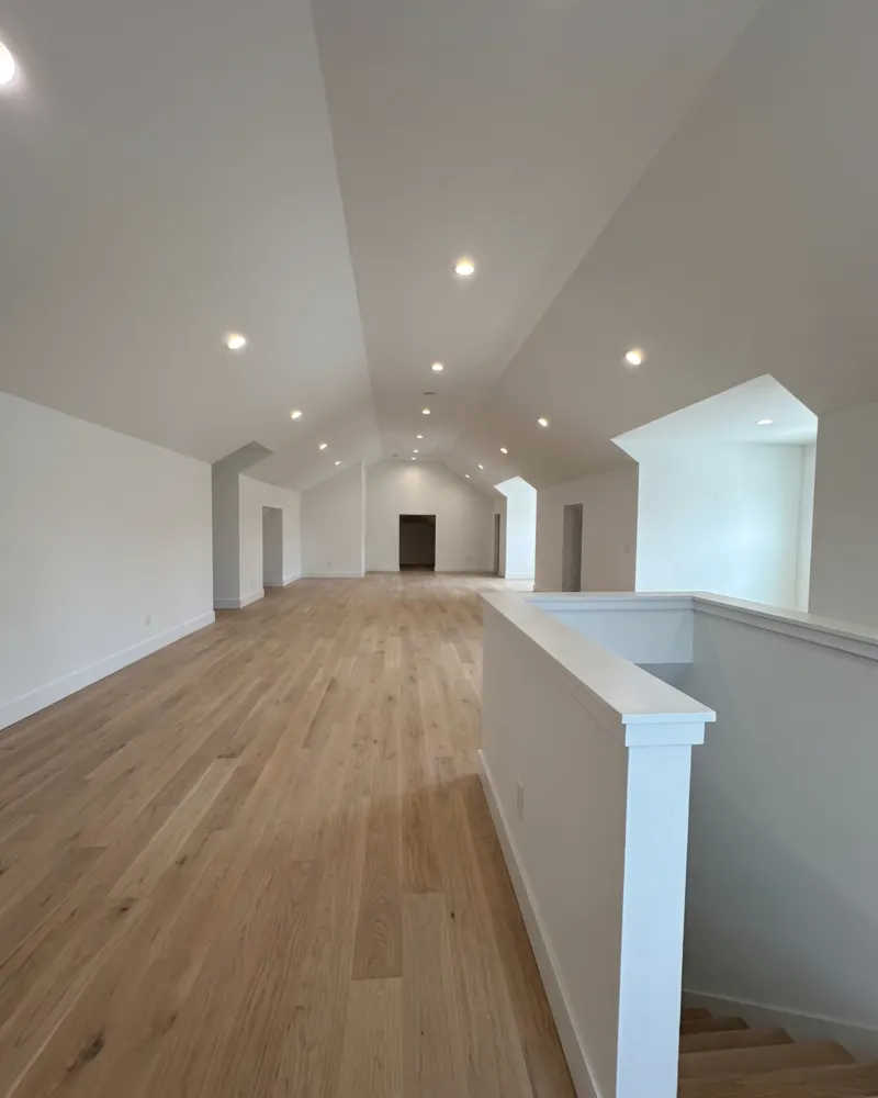 Finished attic with smooth white veneer plaster walls and ceilings