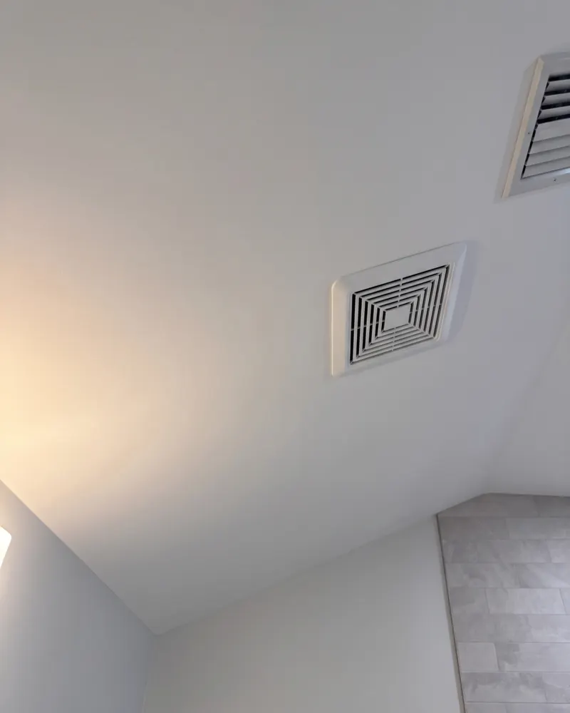 Close-up of the flat, seamless repaired plaster ceiling under side light