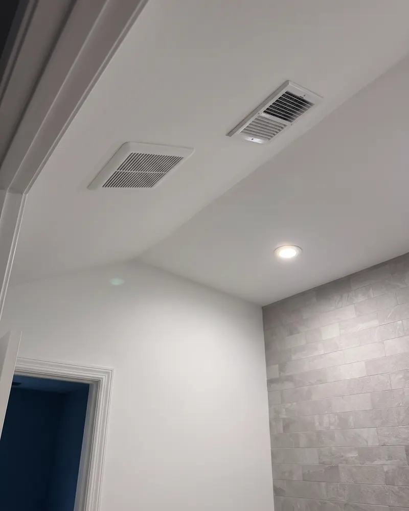 Wide view of the smooth repaired sloped bathroom ceiling