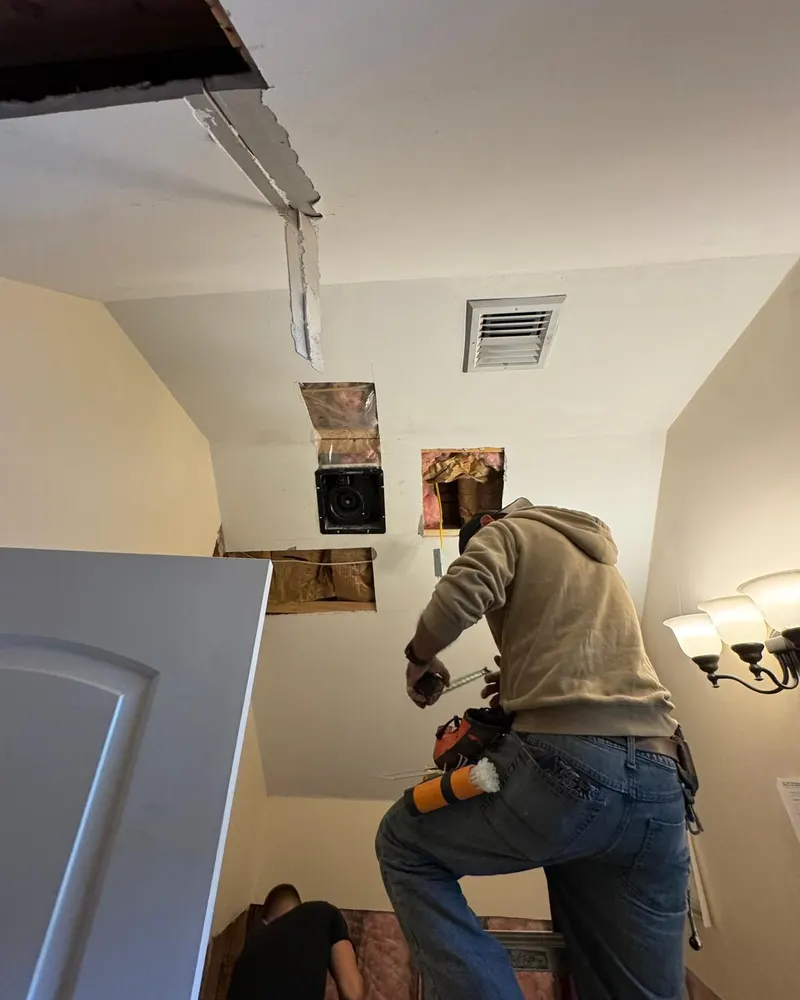 Ezra Plastering crew working on the opened bathroom ceiling