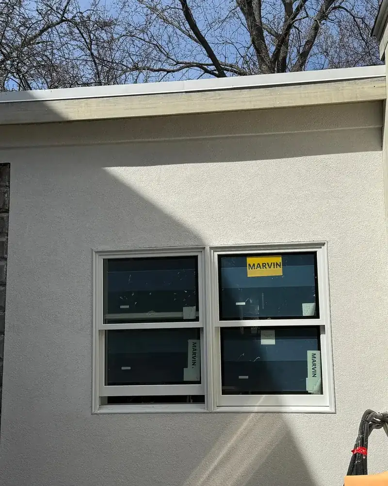 Smooth stucco finish coat around a window, clean edges and even texture