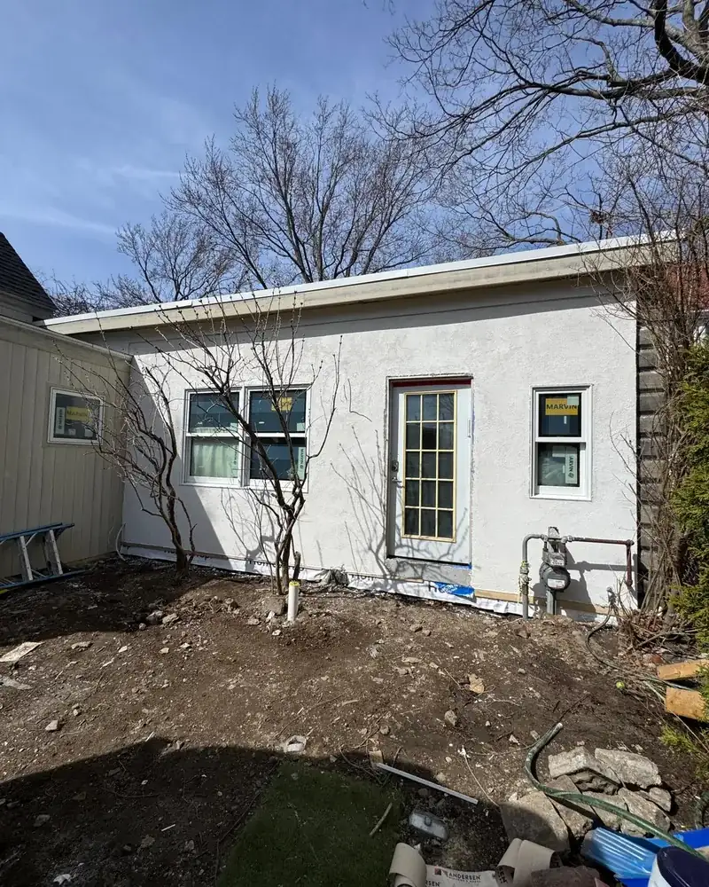 Finished white stucco exterior on a home addition