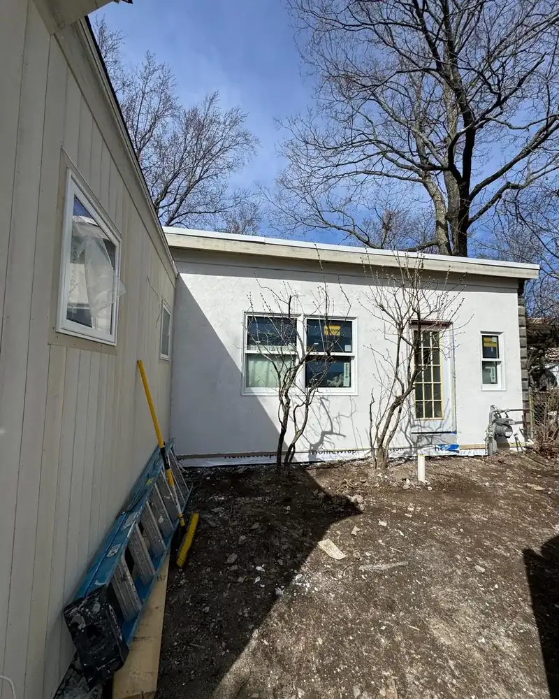 Side view of a finished stucco wall on a home addition