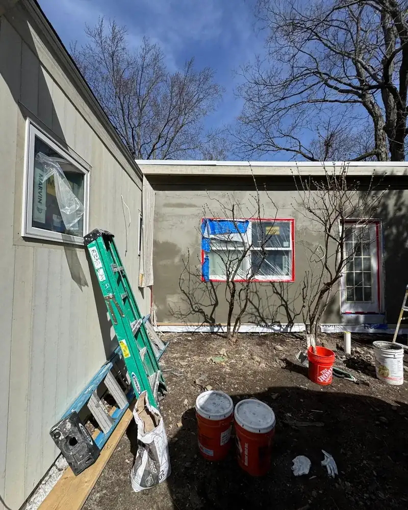 Stucco scratch coat being applied by hand