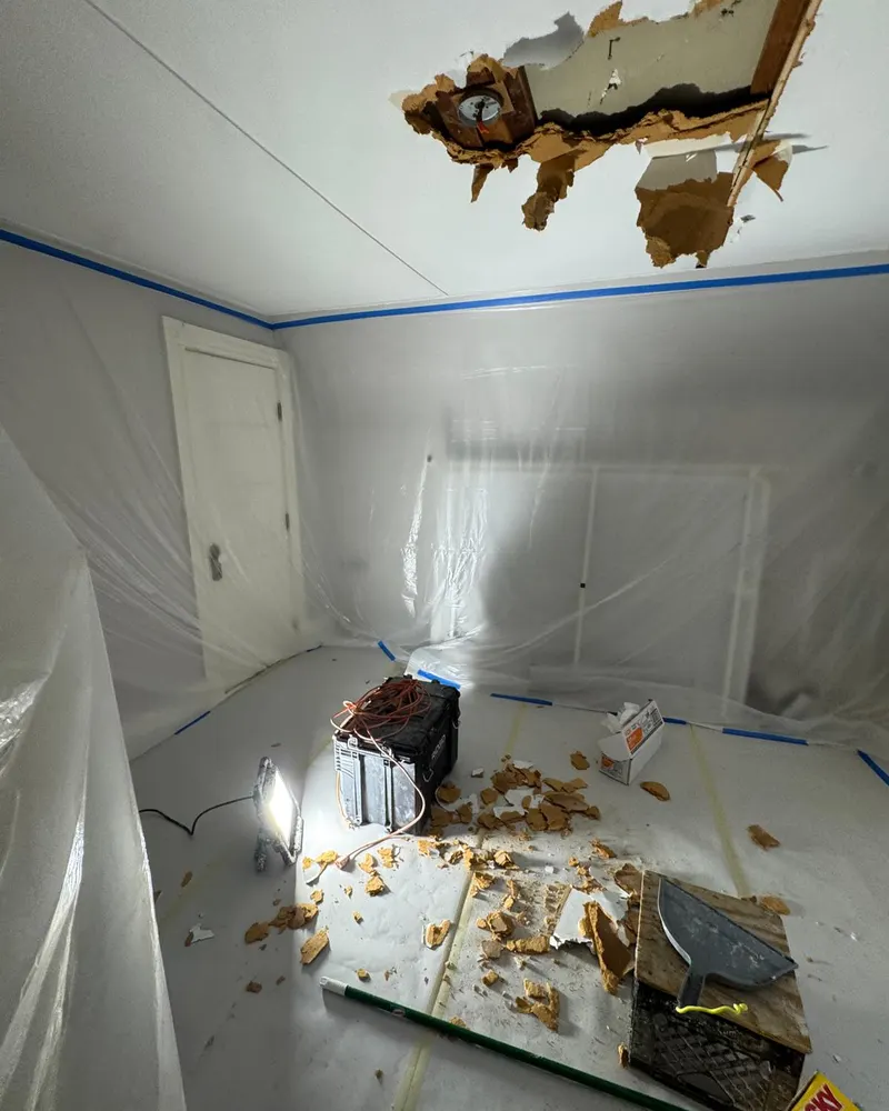 Water damaged ceiling debris on a protected floor